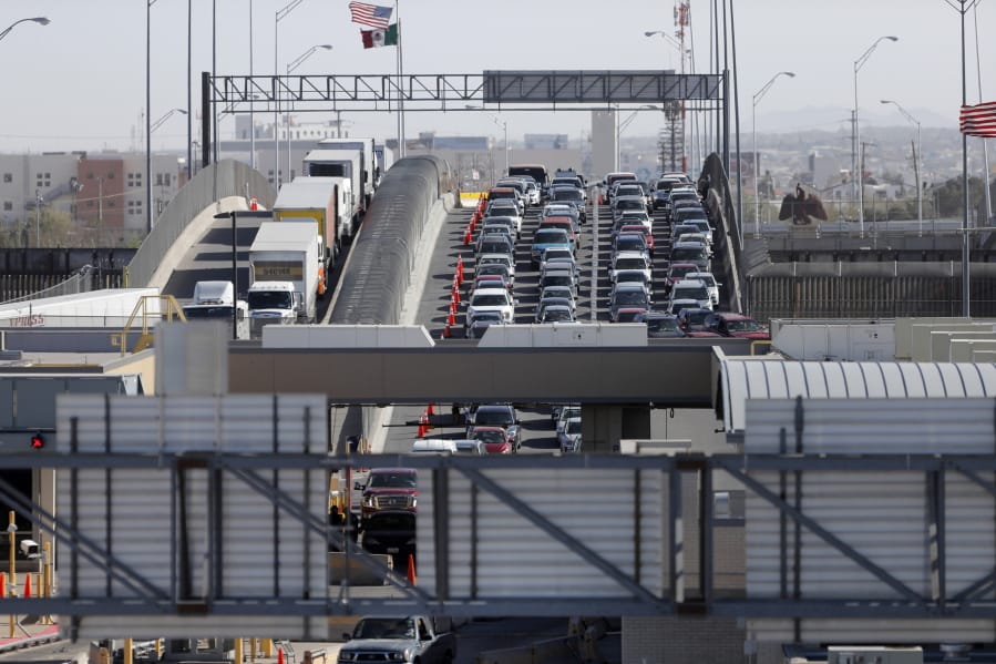 FILE - In this March 29, 2019, file photo, cars and trucks line up to enter the U.S. from Mexico at a border crossing in El Paso, Texas. Authorities in far South Texas say U.S. Border Patrol agents have discovered the bodies of four people, including three children, who appeared to have died from heat exposure after crossing the Rio Grande. Hidalgo County sheriff’s Sgt. Frank Medrano said the bodies of a woman in her early 20s, a toddler and two infants were found Sunday, June, 23, 2019, in or near Anzalduas Park, which borders the river in the city of Mission.