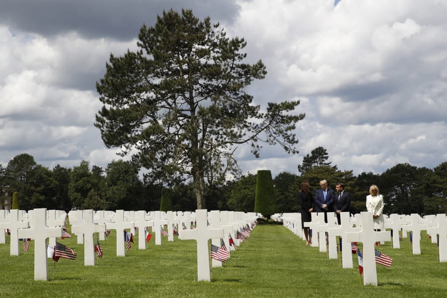 President Donald Trump, first lady Melania Trump, French President Emmanuel Macron and Brigitte Macron, walk through The Normandy American Cemetery, following a ceremony to commemorate the 75th anniversary of D-Day, Thursday, June 6, 2019, in Colleville-sur-Mer, Normandy, France.