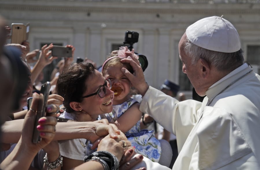 Pope Francis blesses a child during his weekly general audience in St. Peter’s Square, at the Vatican, Wednesday, June 26, 2019.