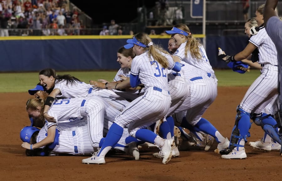 UCLA players celebrates after defeating Oklahoma in the NCAA softball Women’s College World Series in Oklahoma City, Tuesday, June 4, 2019. UCLA won 5-4 in Game 2, taking both games in the best-of-three series.