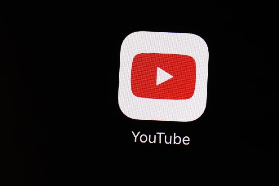 FILE - This March 20, 2018 file photo shows the YouTube app on an iPad in Baltimore. YouTube is updating its hate speech policies to prohibit videos with white supremacist and neo-Nazi content.