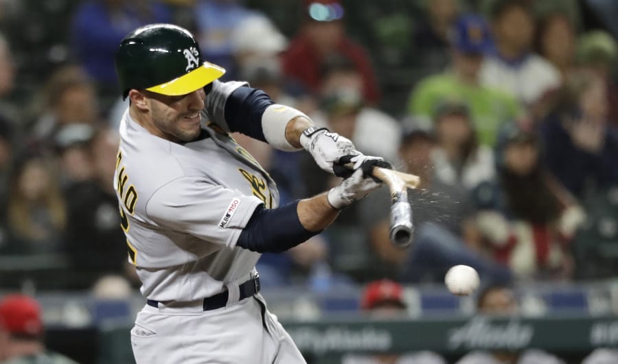 The Athletics’ Ramon Laureano shatters his bat as he hits a grounder in the ninth inning of a baseball game Frida. Mark Canha was out at second, and Laureano was safe at first.