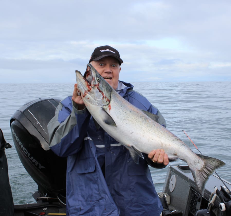 Larry Wells of Sherman, Or, is excited about this big king salmon. He took it while fishing off Long Beach recently with guide Bob Rees, Ocean salmon fishing has been excellent.