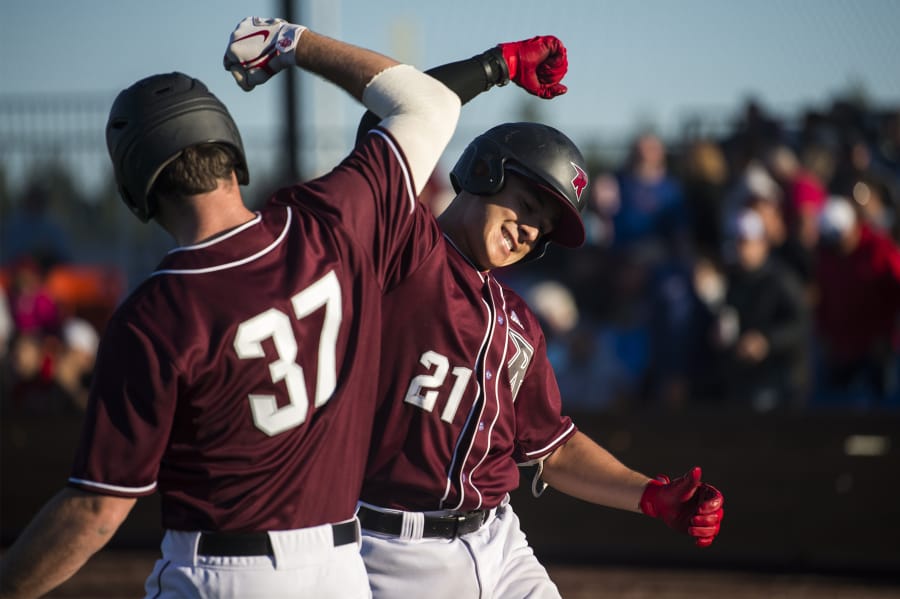 Rifgefield’s Steve Ramirez, right, celebrates scoring against the Port Angeles Lefties at the Ridgefield Outdoor Recreation Complex on Friday night, June 14, 2019.