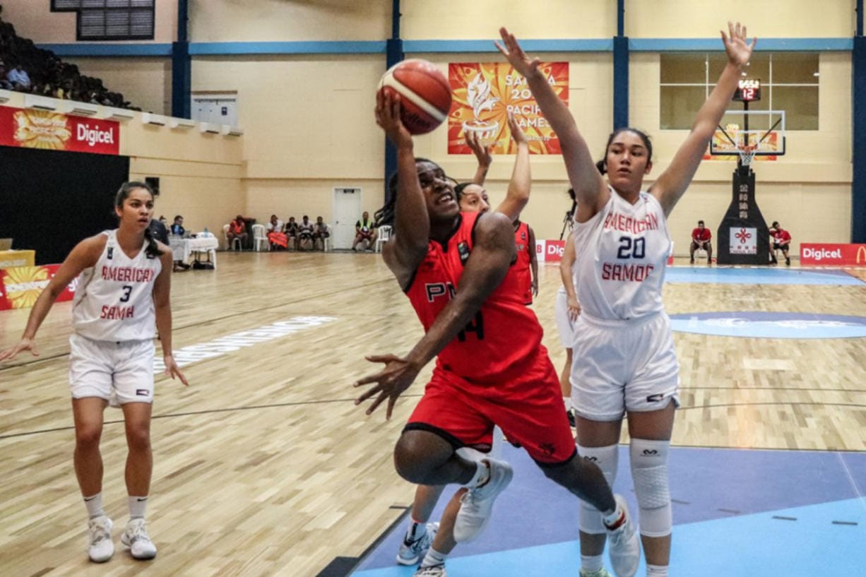 Katie Peneueta (20) defends a shot against Paupa New Guinea at the Pacific Games this month in American Samoa. Peneuata, a junior at Vancouver's Heritage High, helped American Samoa win the gold medal.
