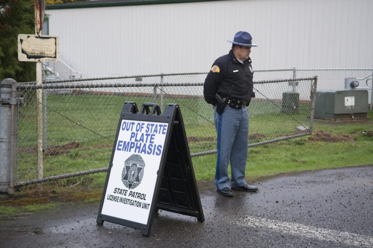 A Washington State Patrol officer mans a checkpoint at a Battle Ground School District school in October 2017, looking for drivers with out-of-state license plates.