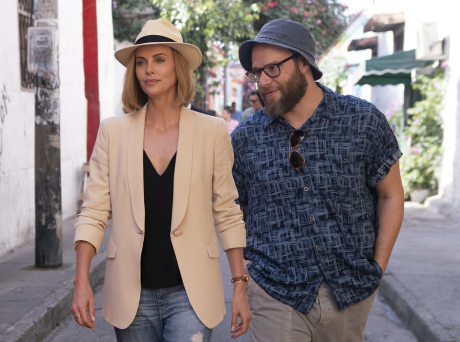 This image released by Lionsgate shows Charlize Theron, left, and Seth Rogen in a scene from “Long Shot.” (Hector Alvarez/Lionsgate via AP)