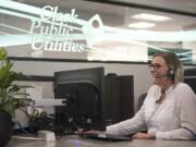 A service representative helps a customer over the phone at Clark Public Utilities in 2019.