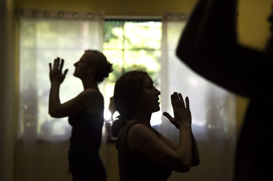 Melonie Nielson, owner of Vancouver Yoga Center, center, leads a Yoga Refinements course last month. “The yoga studio came about out of love and passion for yoga and did not start as a plan to open a yoga business,” she said.