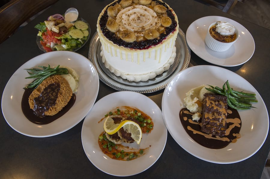 Steve’s Homemade Meatloaf with green beans, counterclockwise from left, is served with Dungeness crab cakes, country fried steak, creme brulee and huckleberry cake at DuckTales Kitchen.