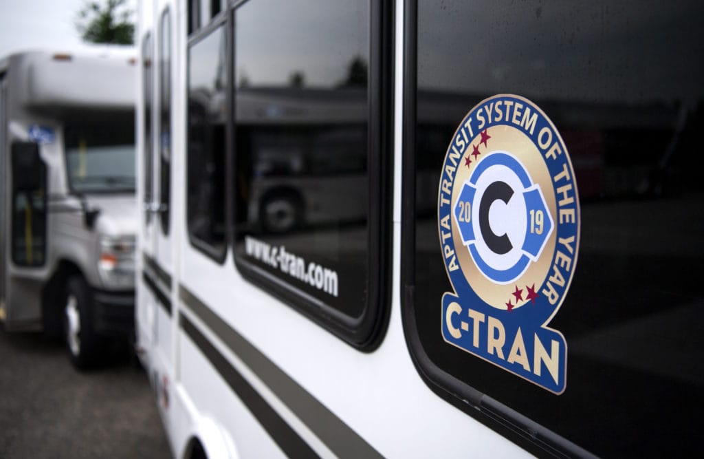 C-Tran pastes new stickers to celebrate their recent award on their buses during a special event at the C-Tran offices in Vancouver on July 9, 2019. C-Tran revealed that The American Public Transportation Association has selected the company as its Transit System of the Year for 2019.