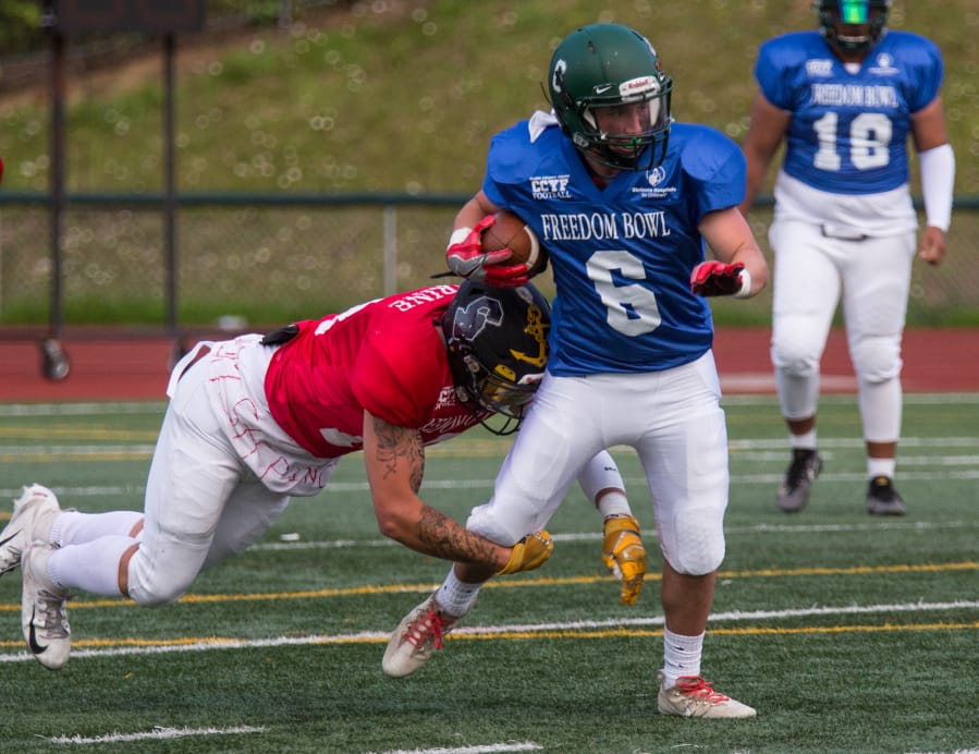 East All Stars’ Trent Hemann (6) attempts to get past West All Stars’ Carter Morse (13) during the first quarter of the Freedom Bowl Classic at McKenzie Stadium, Saturday, July 13.