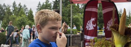 Joshua Cornish, 10, of Vancouver reacts after smelling the rare corpse flower, Titan VanCoug, in bloom at Washington State University Vancouver on Tuesday morning, July 16, 2019. Cornish was one of hundreds of visitors that took in the sight and the smell of the unique flower. "It smelled like garbage," he said.