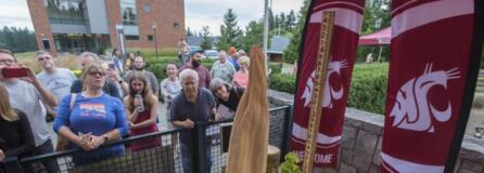 A small crowd gathers to view the rare corpse flower, Titan VanCoug, as it starts to fold inward at Washington State University Vancouver on Wednesday afternoon. The flower, which drew thousands of visitors, was in full bloom on Tuesday, but, as expected, began to decline the following day.