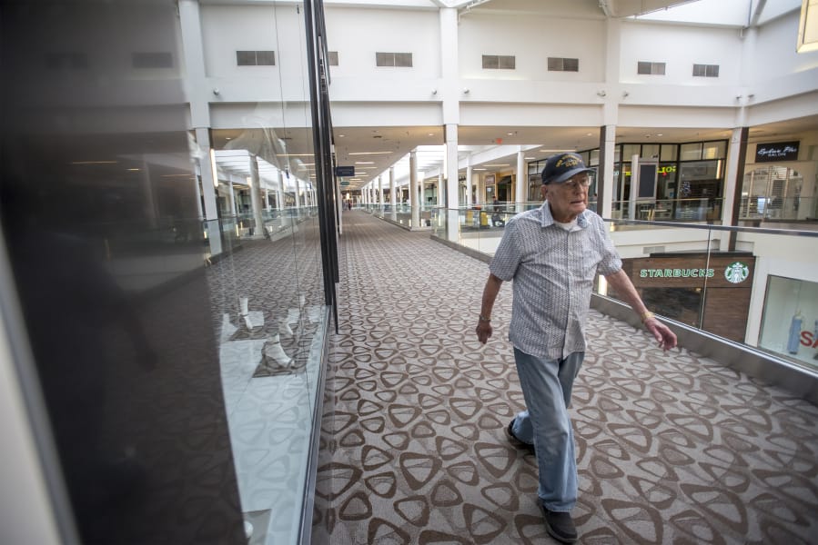 Carl Lingenfelter, a World War II veteran who will turn 100 on Monday, completes a lap of Vancouver Mall during his daily walk through the mall, which unlocks its doors for walkers long before stores open to shoppers.