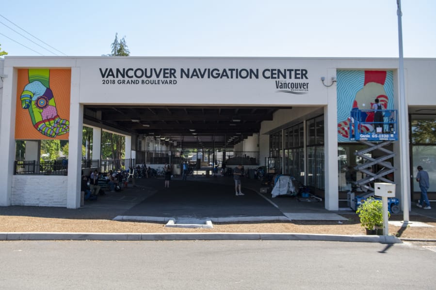 Catya Ledezma, top right, paints two murals Friday afternoon on the Vancouver Navigation Center as part of the 2019 Summer of Murals celebration sponsored by the Clark County Mural Society.