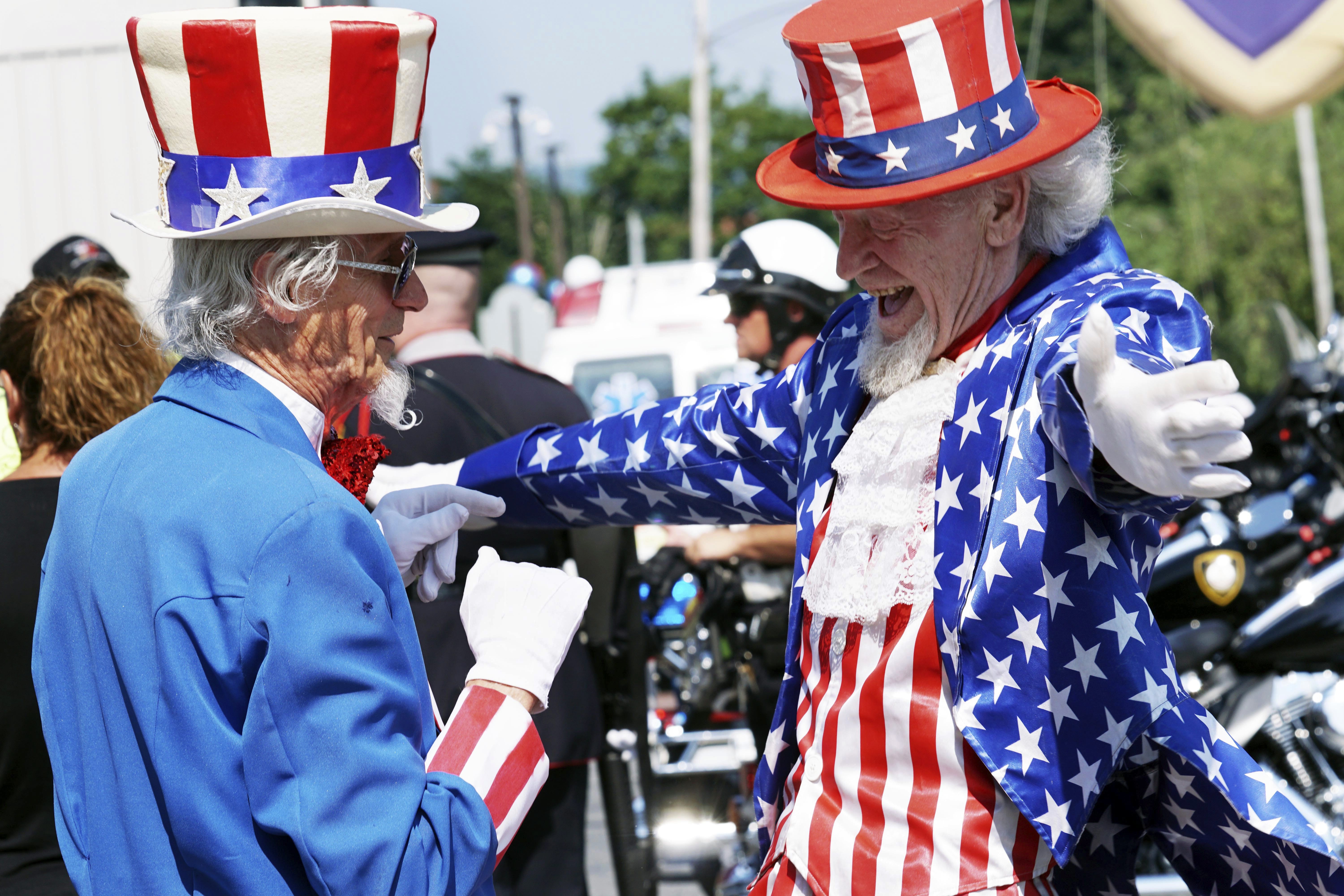 Uncle Sams Fred Polnisch and Gordon Dunham greet each other before the Fourth of July Parade, Thursday July 4, 2019, in the Pittsfield, Mass.