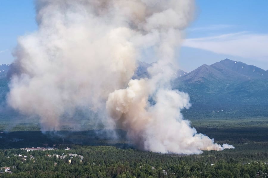 A brush fire burns Tuesday in South Anchorage, Alaska. This heat wave for the northernmost state comes right on the heels of a June that was well above average and filled with wildfires that are persisting and/or growing into July.