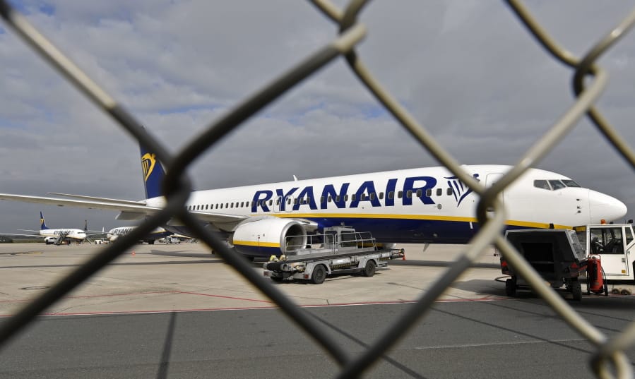 FILE - In this Wednesday, Sept. 12, 2018 file photo, a Ryanair plane is parked at the airport in Weeze, Germany. Europe’s biggest airline by passengers, budget carrier Ryanair, will cut flights and close some of its bases beginning this winter because of the delay to deliveries of the Boeing 737 Max plane, which has been grounded globally after two fatal crashes. The airline warned Tuesday, July 16, 2019, its growth in European summer traffic for 2020 will be lower than expected because of the slowed deliveries.