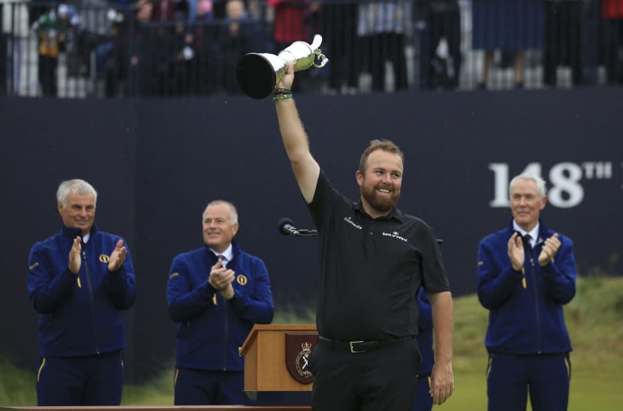 Ireland’s Shane Lowry smiles as he holds the Claret Jug trophy aloft after being presented with it for winning the British Open Golf Championships at Royal Portrush in Northern Ireland, Sunday, July 21, 2019.(AP Photo/Jon Super)