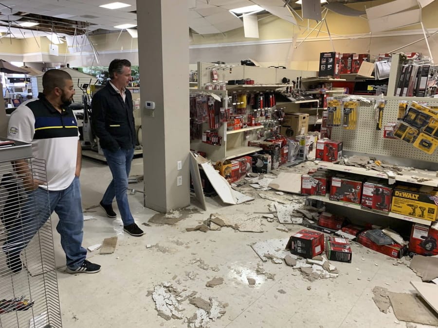 In this photo provided by the Cal OES, Governor's Office of Emergency Services, California Gov. Gavin Newson, right, tours earthquake damage inside a Sears Hometown Store Saturday, July 6, 2019, in Ridgecrest, Calif. Officials in Southern California expressed relief Saturday that damage and injuries weren't worse after the largest earthquake the region has seen in nearly 20 years, while voicing concerns about the possibility of major aftershocks in the days and even months to come.