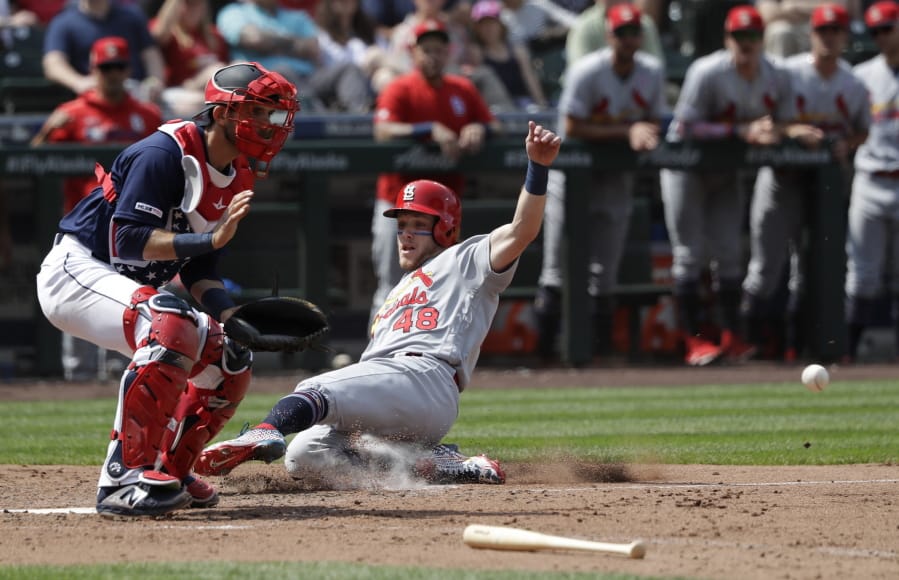 St. Louis Cardinals’ Harrison Bader (48) scores ahead of the throw to Seattle Mariners catcher Austin Nola during the seventh inning of a baseball game Thursday, July 4, 2019, in Seattle.