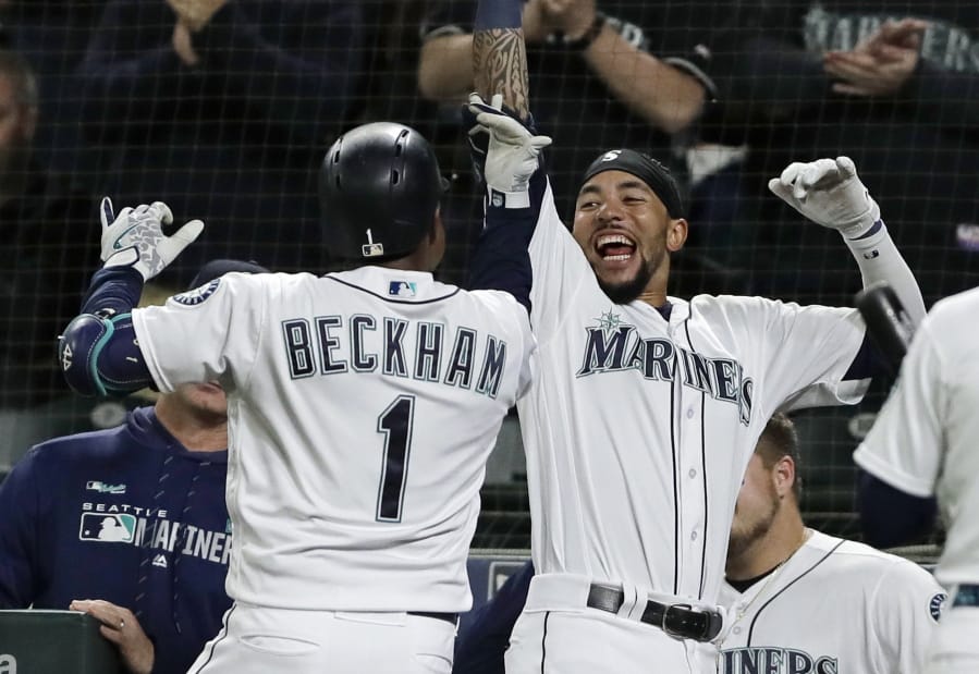 Seattle Mariners' Tim Beckham (1) celebrates with J.P. Crawford, right, after Beckham hit a go-ahead solo home run during the eighth inning of a baseball game against the St. Louis Cardinals, Tuesday, July 2, 2019, in Seattle. (AP Photo/Ted S.