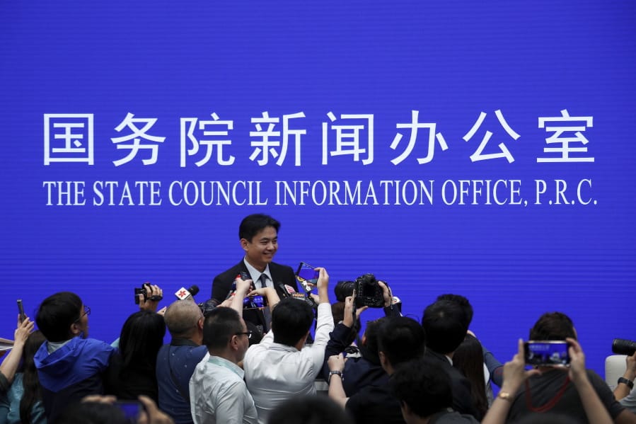 Yang Guang, spokesman of the Hong Kong and Macau Affairs Office of the State Council, is approached by reporters as he prepares to leave after a press conference about the ongoing protests in Hong Kong, at the State Council Information Office in Beijing, Monday, July 29, 2019. Yang said some Western politicians are stirring unrest in Hong Kong in hopes of creating difficulties that will impede China’s overall development.