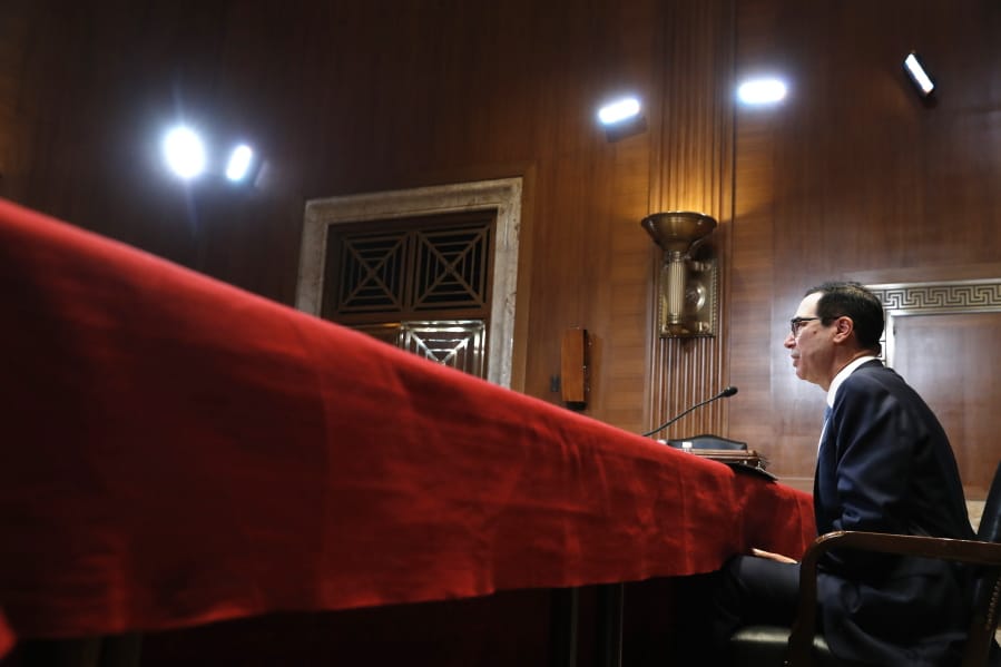 FILE- In this May 15, 2019, file photo Treasury Secretary Steve Mnuchin testifies about the budget during a Financial Services and General Government subcommittee hearing on Capitol Hill in Washington. In a letter Friday, July 12, to House and Senate leaders, Mnuchin told congressional leaders that Congress should raise the debt ceiling before leaving for its August recess. He says he could run out of maneuvering room to avoid an unprecedented default on the national debt before lawmakers return.