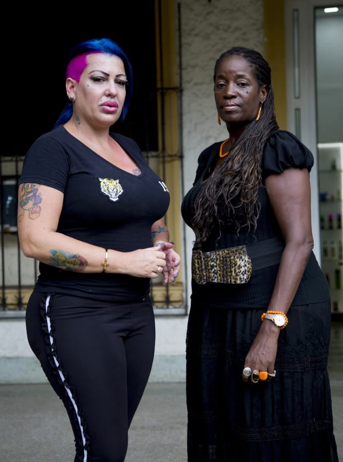 In this June 28, 2019, photo, Dianelys Alfonso, left, singer stands with her lawyer Deyni Terry, for a photo during an interview with The Associated Press in Havana, Cuba. Alfonso publicly denounced another renowned musician, flutist and bandleader José Luis Cortés, accusing him of repeatedly hitting and raping her during her time as vocalist for NG La Banda. Terry said she and her client are investigating whether they can bring charges of abuse and sexual assault against Cortés many years after the alleged crimes took place.