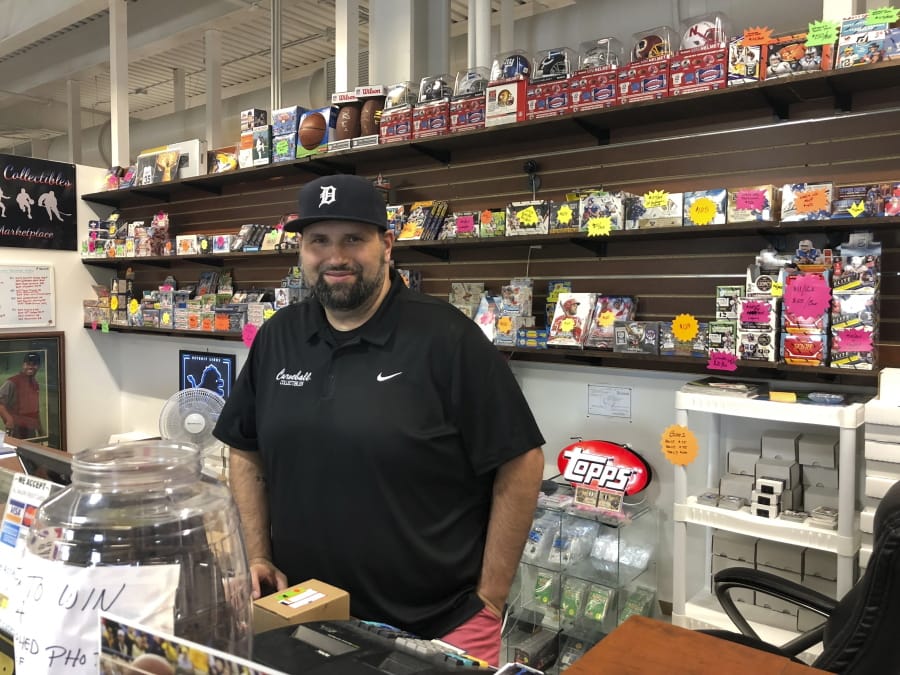 Mike Wilson, who runs Curveball Sportscards and Collectibles at the SVRC Marketplace in downtown Saginaw, Michigan works in his store. He supports President Donald Trump and credits him for a good economy.