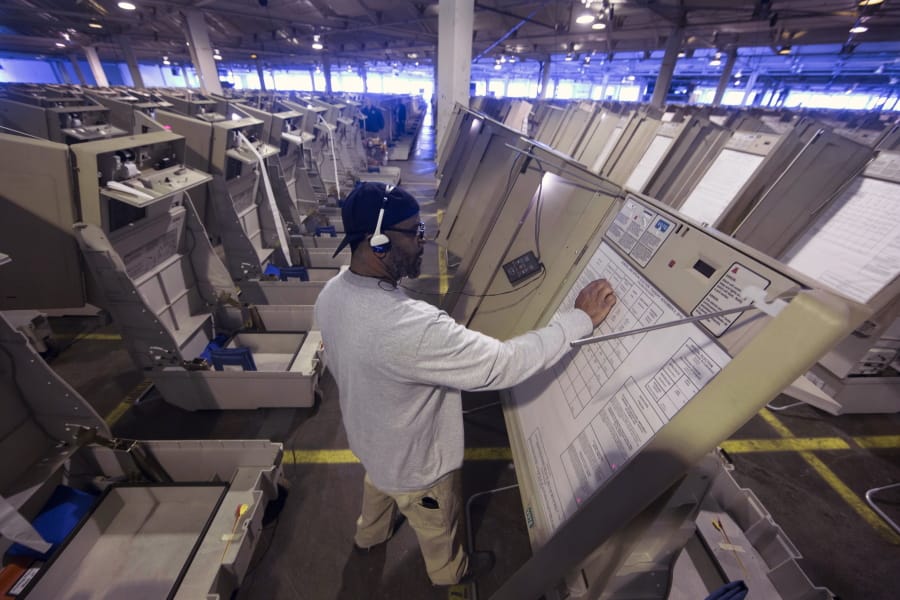 In this Oct. 14, 2016 file photo, a technician works to prepare voting machines to be used in an upcoming election in Philadelphia. On Friday July 5, 2019, Pennsylvania Gov. Tom Wolf vetoed legislation that carried $90 million to help counties buy new voting machines before 2020’s elections, but ordered changes to election laws that the Democrat says don’t help improve voting security or access.