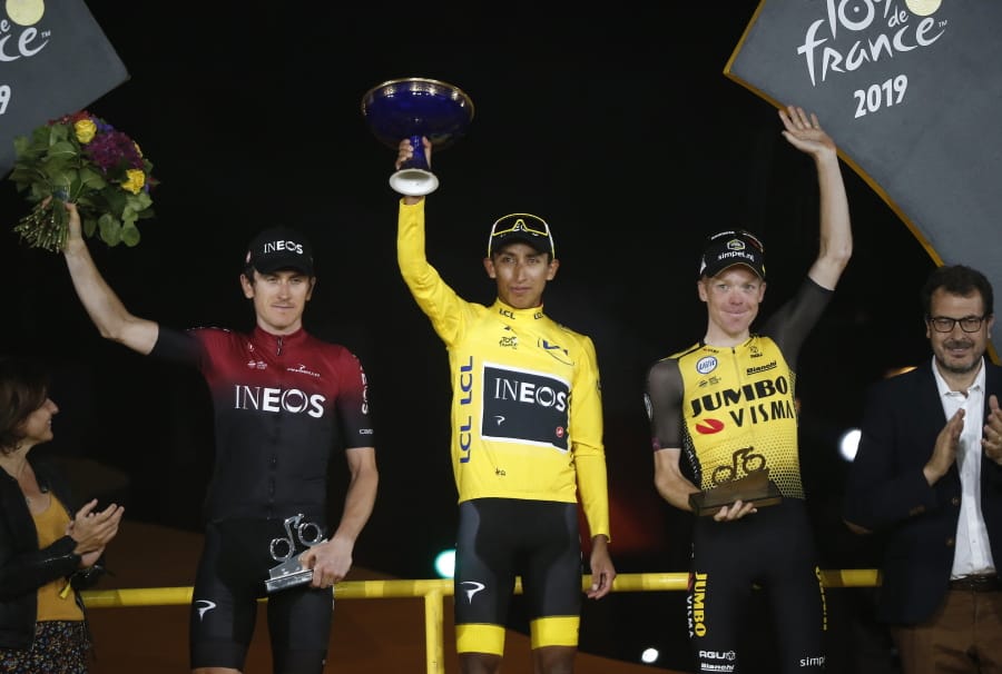 Colombia’s Egan Bernal, the winner, center, Britain’s Geraint Thomas, who placed second, left, and the Netherlands’ Steven Kruijswijk, third, stand on the podium of the Tour de France cycling race in Paris, France, Sunday, July 28, 2019.