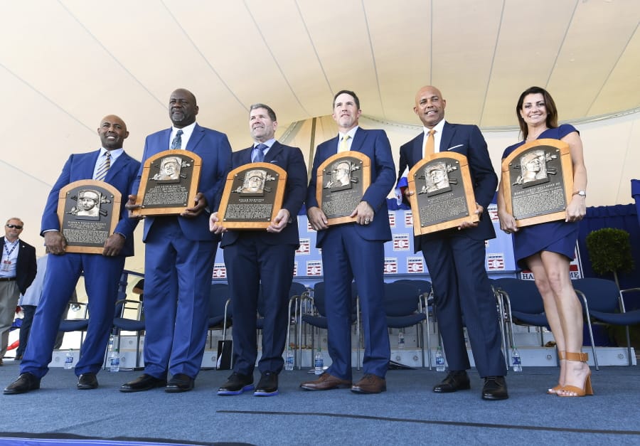 National Baseball Hall of Fame inductees Harold Baines, Lee Smith, Edgar Martinez, Mike Mussina, Mariano Rivera , and Brandy Halladay window of the late Roy Halladay hold their plaques for photos after the induction ceremony at Clark Sports Center on Sunday, July 21, 2019, in Cooperstown, N.Y.
