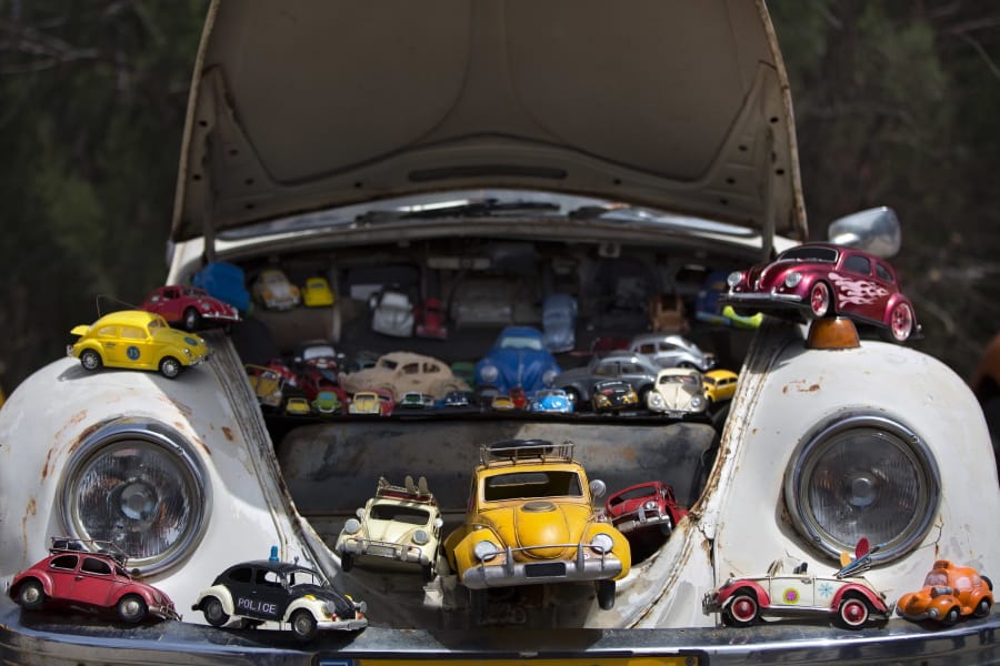 FILE - In this April 21, 2017, file photo a collection of VW beetles car toys seen on Volkswagen Beetle displayed during the annual gathering of the “Beetle Club” in Yakum, central Israel. Volkswagen is halting production of the last version of its Beetle model in July 2019 at its plant in Puebla, Mexico, the end of the road for a vehicle that has symbolized many things over a history spanning eight decades since 1938.