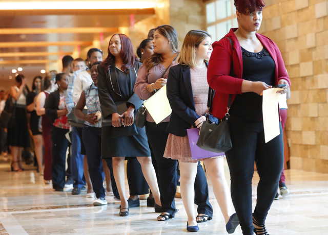 In this Tuesday, June 4, 2019 photo, job applicants line up at the Seminole Hard Rock Hotel & Casino Hollywood during a job fair in Hollywood, Fla. On Friday, July 5, the U.S. government issues the June jobs report.