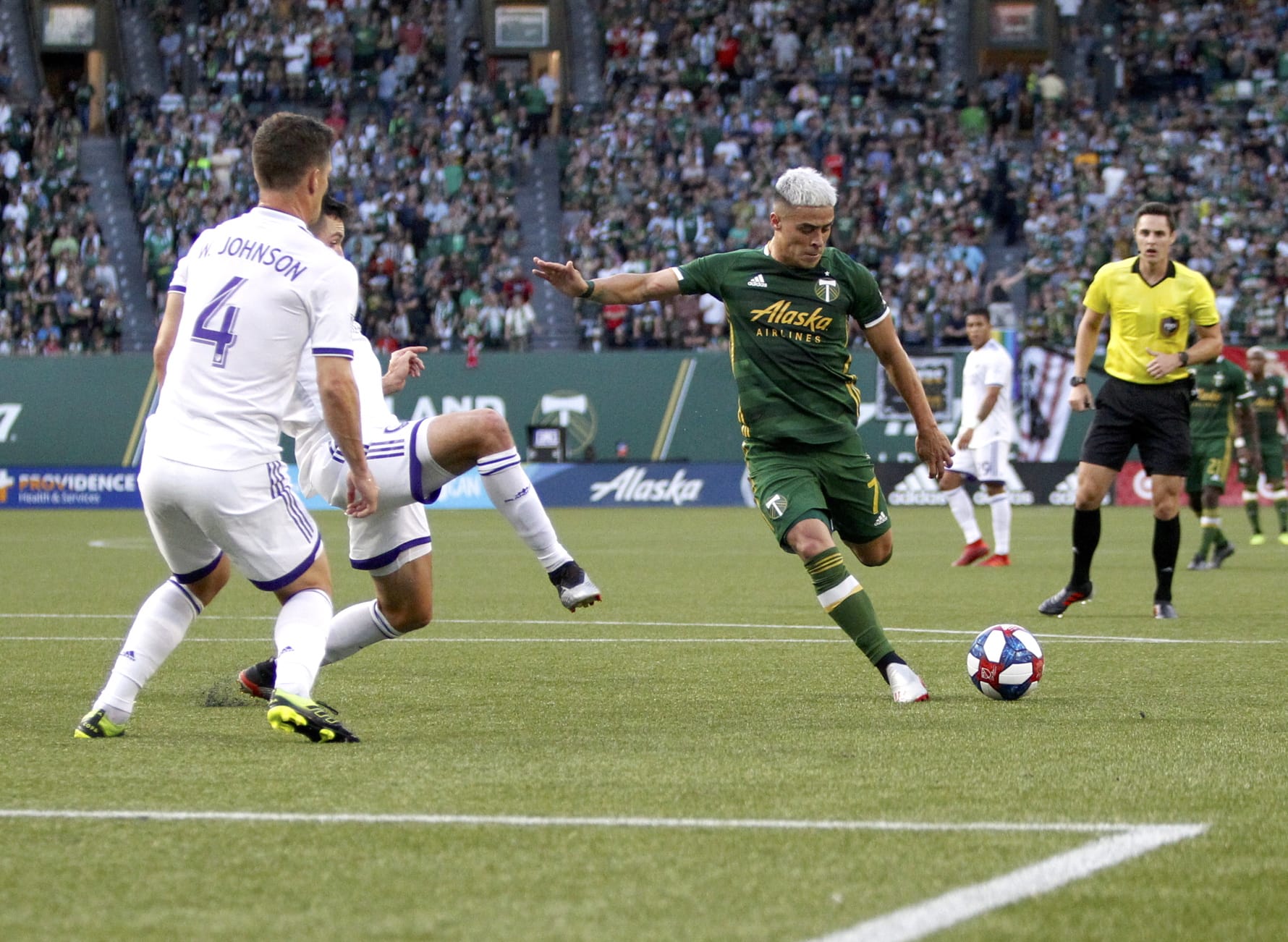 Portland Timbers' Brian Fernandez attempts a shot on goal as Orlando City players, including Will Johnson (4), defend during an MLS soccer match Thursday, July 18, 2019, in Portland, Ore.