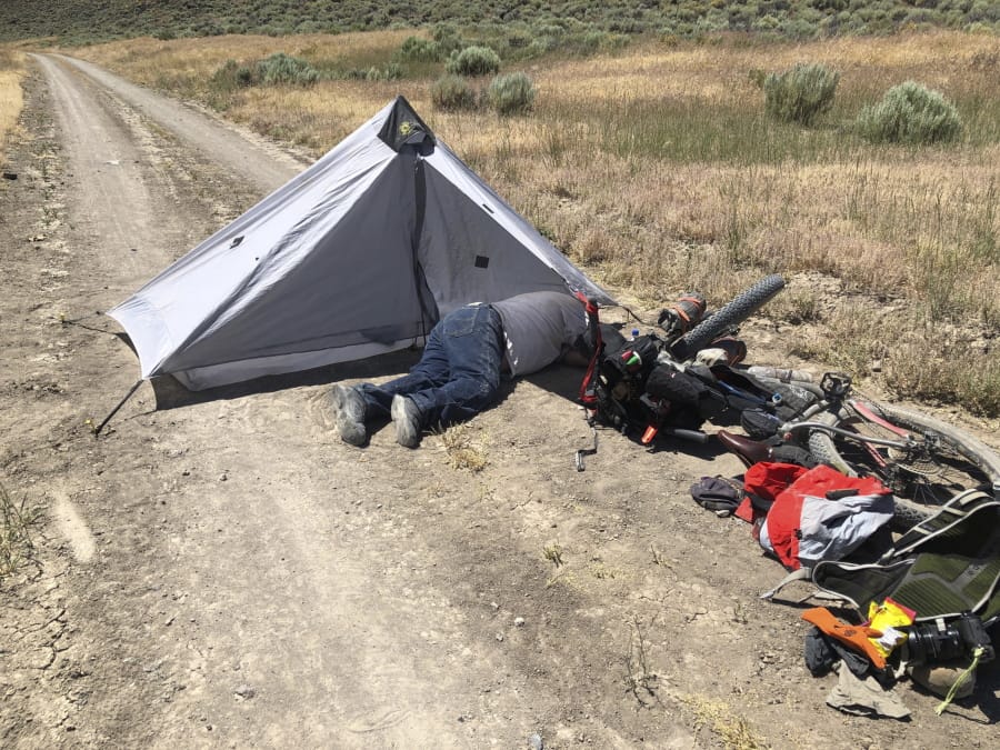 Gregory Randolph, 73, lies on a dirt road July 18 in the remote Oregon high desert. He spent four days stranded with his two dogs and was rescued when a long-distance mountain biker discovered him near death, authorities said Thursday.