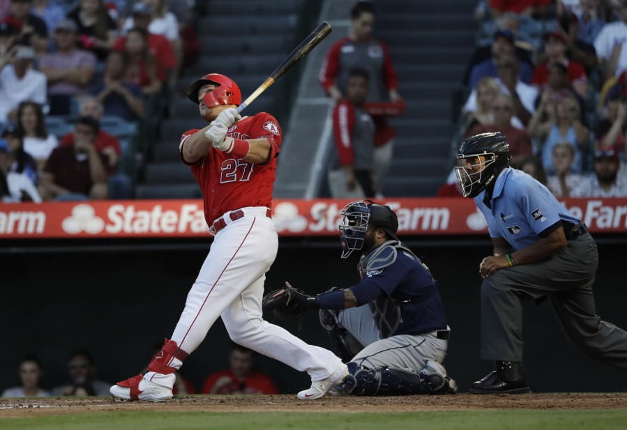 Los Angeles Angels' Mike Trout follows through on a two-run home run against the Seattle Mariners during the third inning of a baseball game Saturday, July 13, 2019, in Anaheim, Calif.