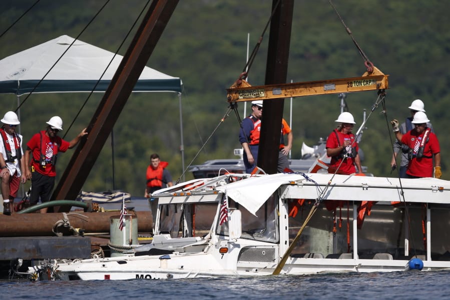 FILE - In this July 23, 2018, file photo, a duck boat that sank in Table Rock Lake in Branson, Mo., is raised after it went down the evening of July 19 after a thunderstorm generated near-hurricane strength winds, killing 17 people. A year after a duck boat sank and killed 17 people in a Missouri lake, the future of the tourist attraction remains a topic of debate.
