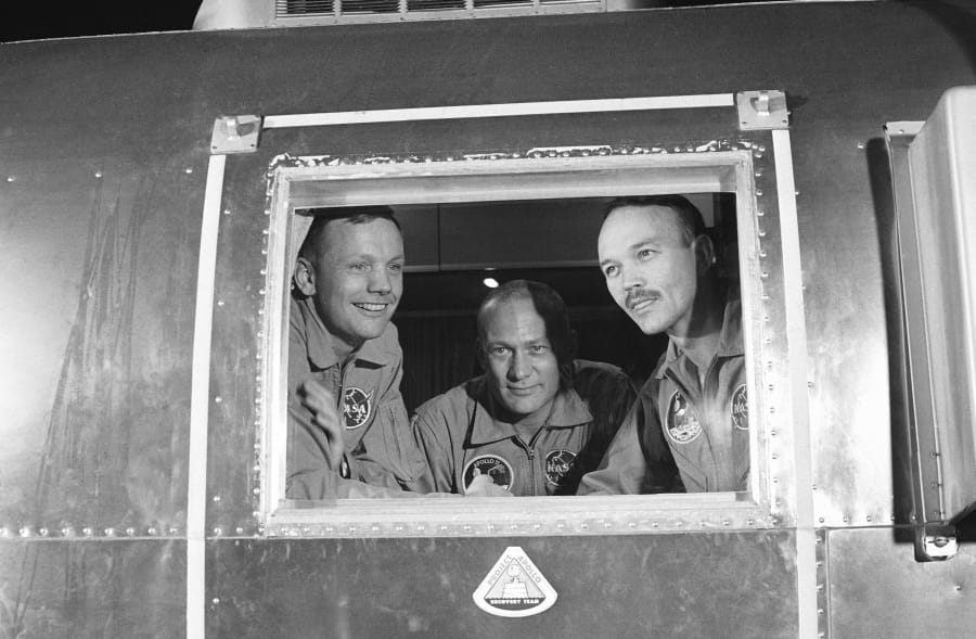 Apollo 11 crew members, from left, Neil Armstrong, Buzz Aldrin and Michael Collins sit inside a quarantine van in Houston on July 27, 1969.