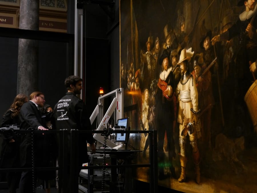 Technicians and researchers check equipment set up inside a glass chamber as they begin to study Rembrandt’s ‘Night Watch’ masterpiece, at the Rijksmuseum in Amsterdam, Monday July 8, 2019.