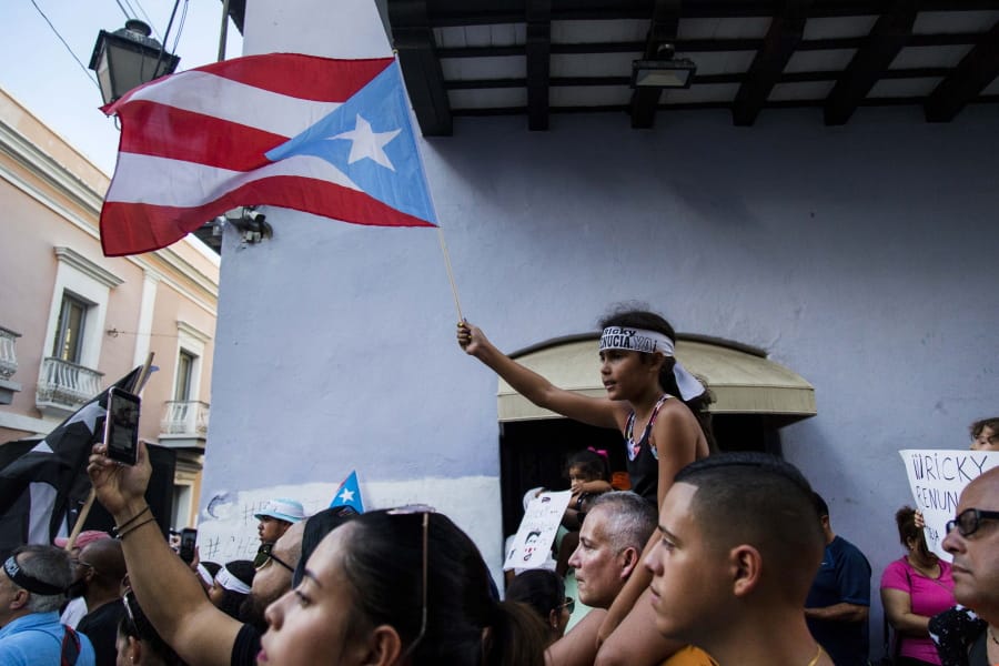 Demonstrators protest against Gov. Ricardo Rossello in San Juan, Puerto Rico, Sunday, July 21, 2019. Puerto Rico’s embattled governor says he will not seek re-election but will not resign as the island’s leader, though he will step down as head of his pro-statehood party. (AP Photo/Dennis M.