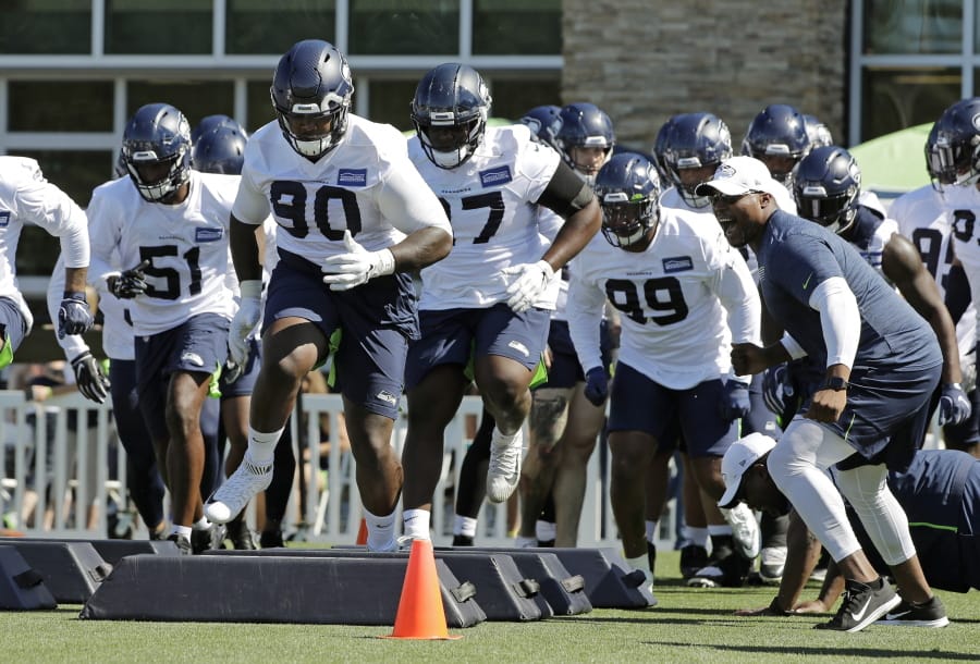 Seahawks defensive tackle Jarran Reed (90) runs a drill with teammates Thursday. Reed learned this week he will be suspended from the first six games of the season by the league. Ted S.