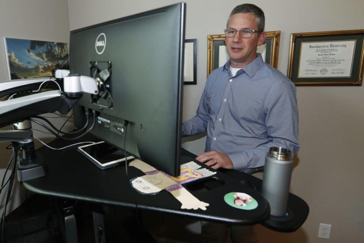 Software engineer Joe Wilson works in his home in Highlands Ranch, Colo.