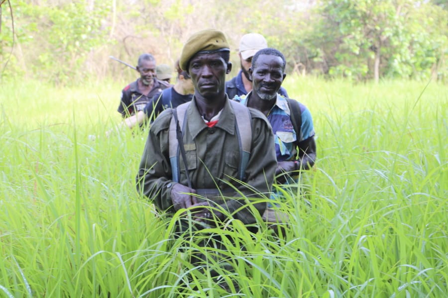 In this photo of Saturday March 16 2019, Rangers walk in a field near the Bire Kpatous game reserve along the Congolese border. South Sudan is trying to rebuild its vast national parks and game reserves following a five-year civil war that killed nearly 400,000 people. The conflict stripped the country of much wildlife but biodiversity remains rich with more than 300 mammal species, including 11 primates, but poaching is a growing threat.
