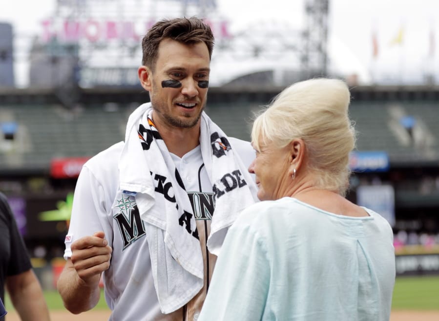 Seattle Mariners’ Ryan Court, left, talks with his mother, Anita Court, after he made his first major-league start in a baseball game against the Detroit Tigers, Saturday, July 27, 2019, in Seattle. Court had three RBIs from two hits and the Mariners won 8-1. (AP Photo/Ted S.
