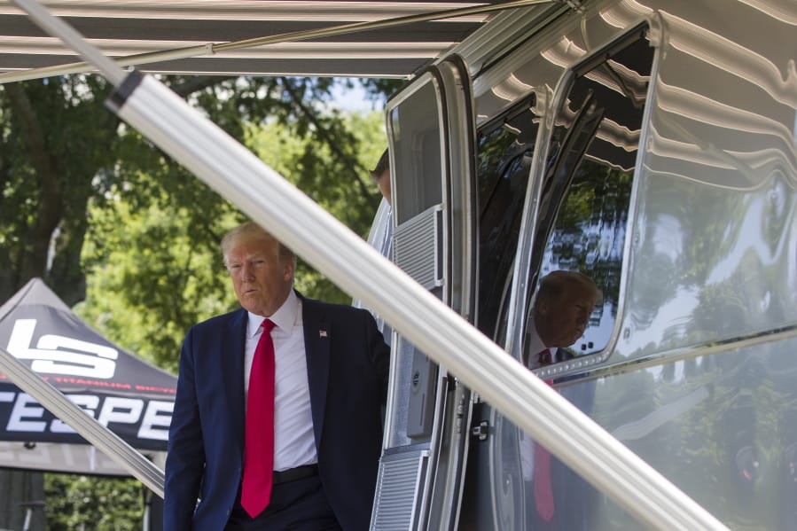President Donald Trump steps out of an Airstream trailer from Ohio, during a Made in America showcase on the South Lawn of the White House, Monday, July 15, 2019, in Washington.