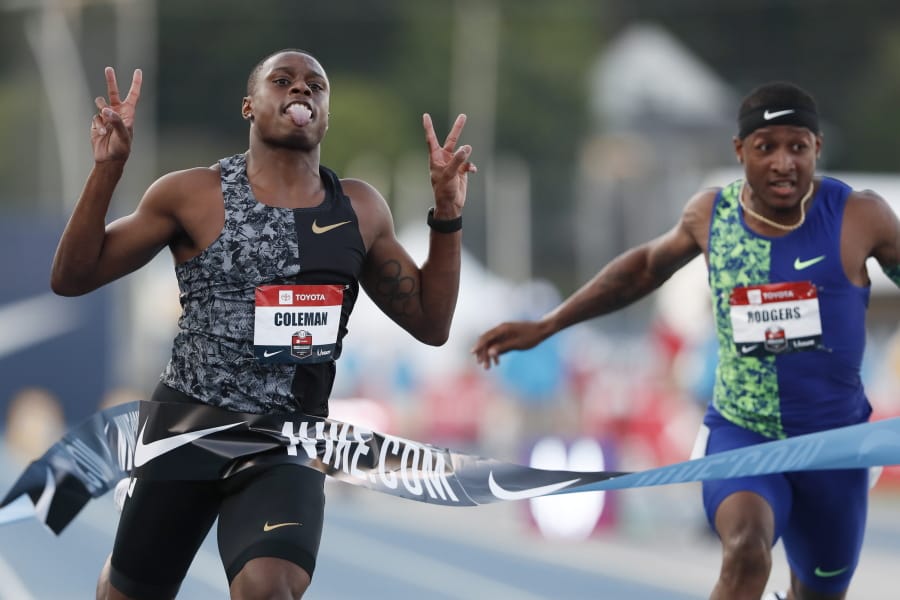 Christian Coleman celebrates in front of Michael Rodgers, right, as he wins the men’s 100-meter dash final at the U.S. Championships athletics meet, Friday, July 26, 2019, in Des Moines, Iowa.