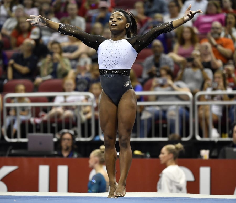 Simone Biles begins her floor exercise routine during the GK US Classic gymnastics meet in Louisville, Ky., Saturday, July 20, 2019. (AP Photo/Timothy D.